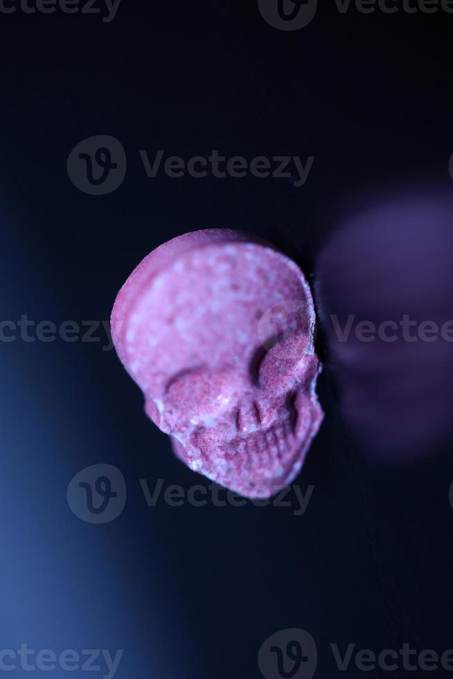 Pink skull ecstasy pill close up background high quality print purple army dope narcotics substance high dose psychedelic way of life photo