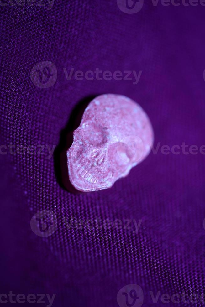 Pink skull ecstasy pill close up background high quality print purple army dope narcotics substance high dose psychedelic way of life photo