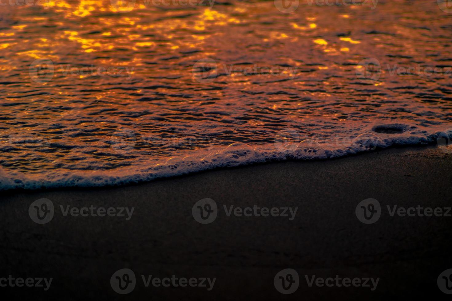 Closeup waves shot at sunset photo