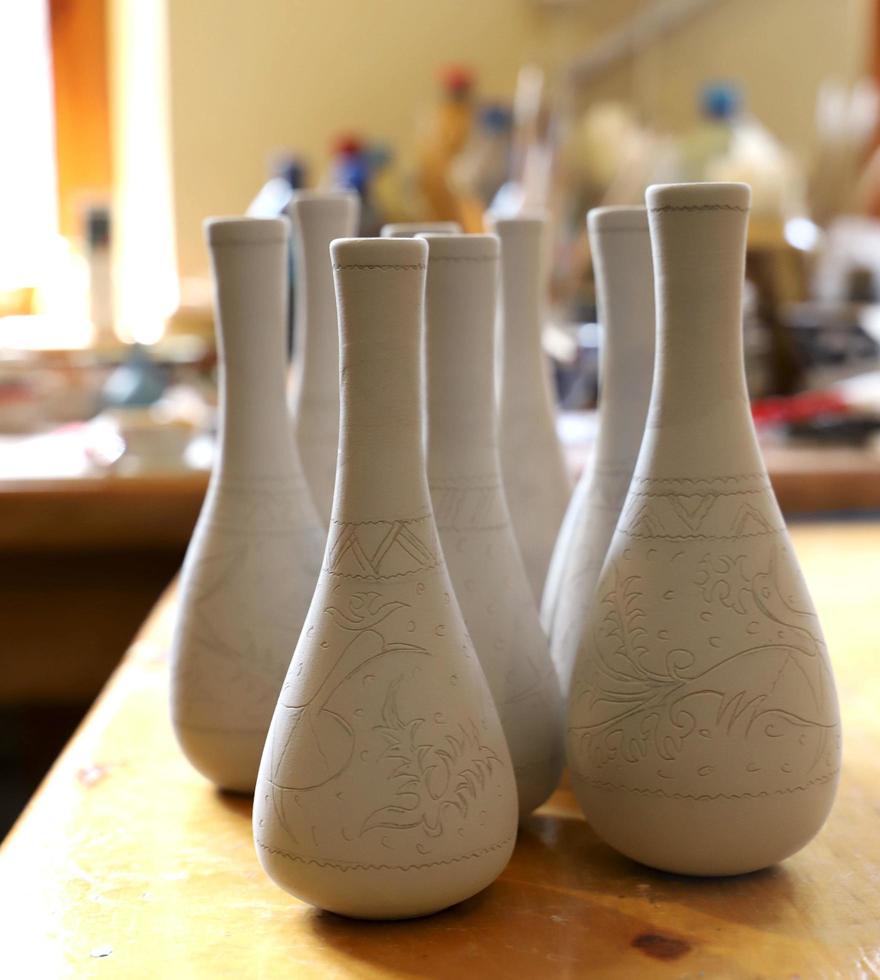 The  workshop of the artist potter. White ceramic vases are ready to be painted. photo