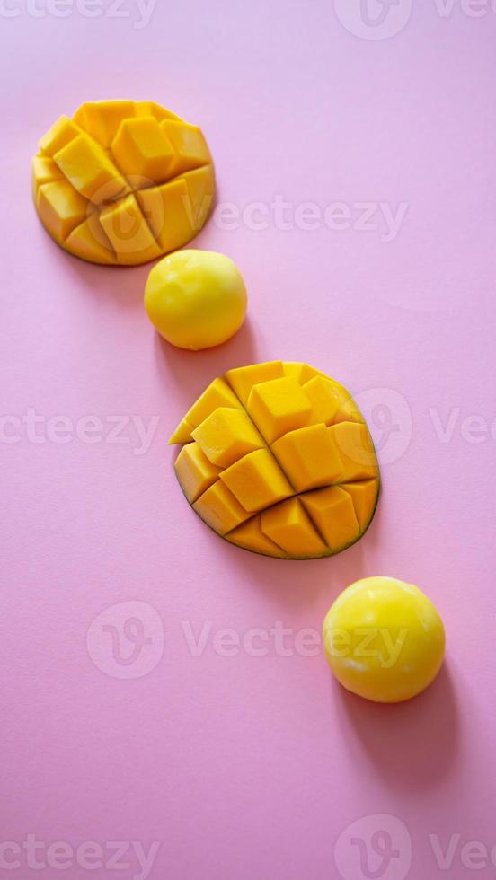 Tasty dessert Mochi with mango fruit on pink background photo