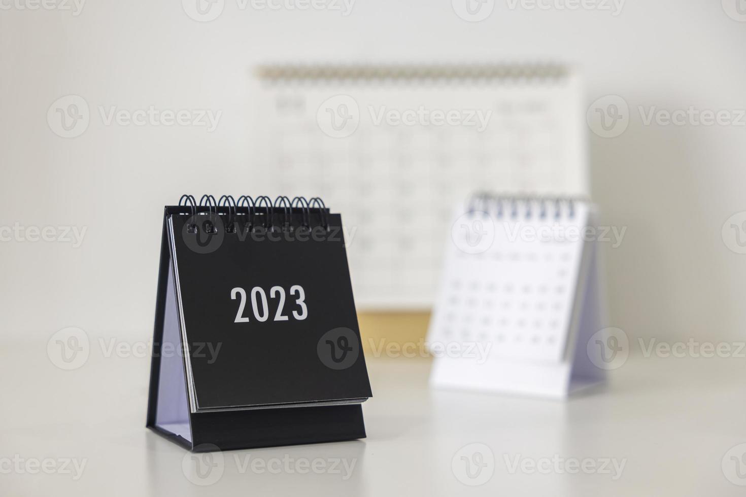 2023 business calendar on office table in new year day. Make a work plan for the start of the year. Concept about Celebration, Business, Christmas, New Year. photo