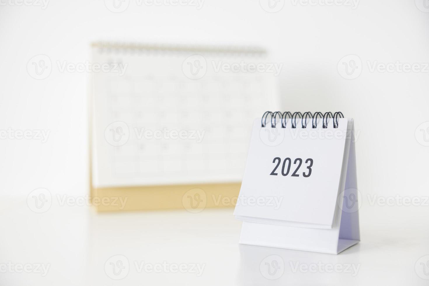 Calendario comercial 2023 en la mesa de la oficina en el día de año nuevo. hacer un plan de trabajo para el inicio del año. concepto sobre celebración, negocios, navidad, año nuevo. foto