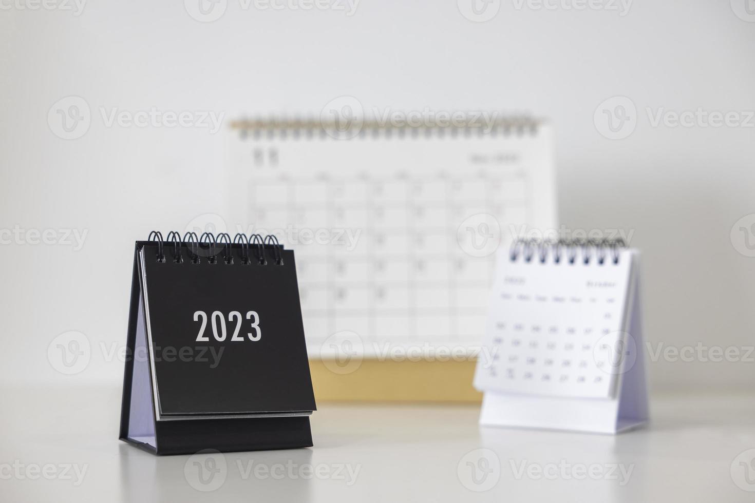 2023 business calendar on office table in new year day. Make a work plan for the start of the year. Concept about Celebration, Business, Christmas, New Year. photo