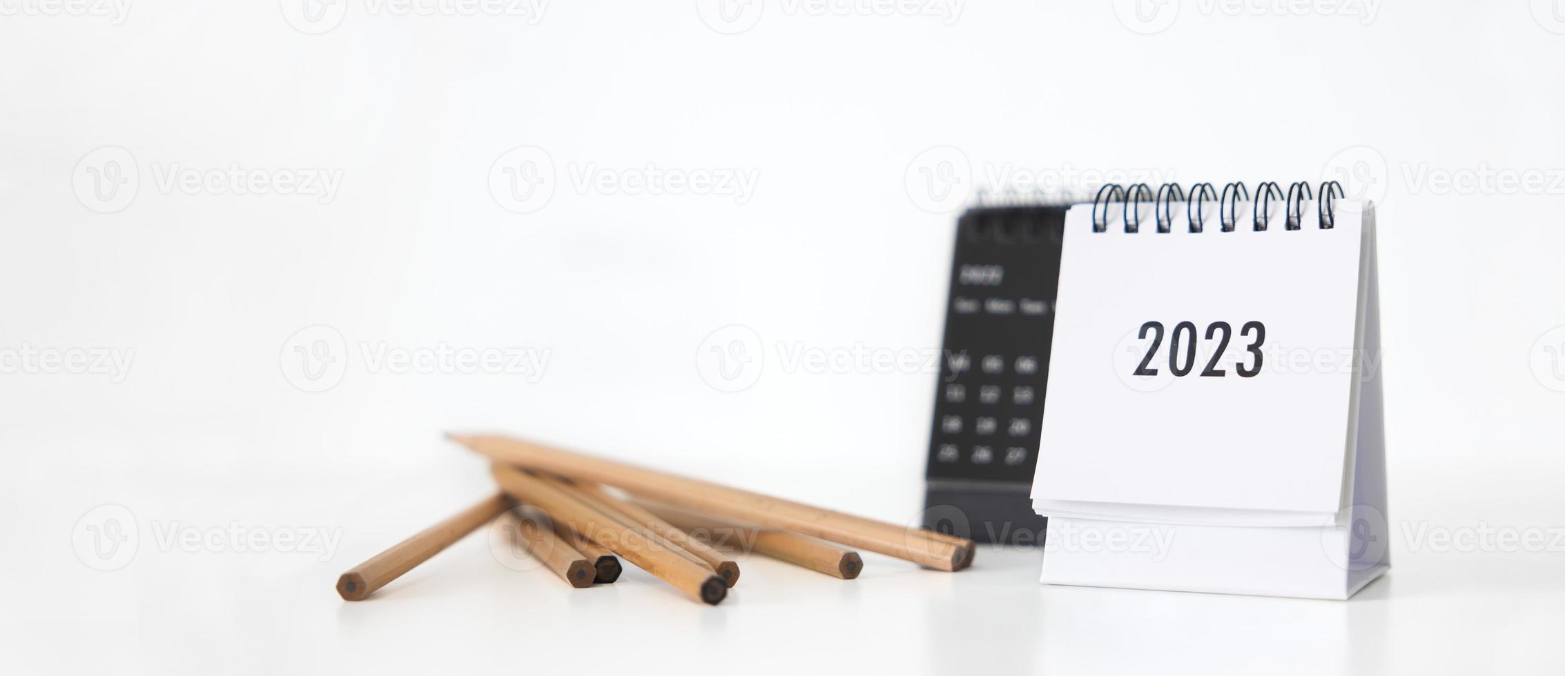 New year 2023 business calendar and pencil on office table in new year day. Make a work plan for the start of the year. Concept about Celebration, Business, Christmas, New Year. photo