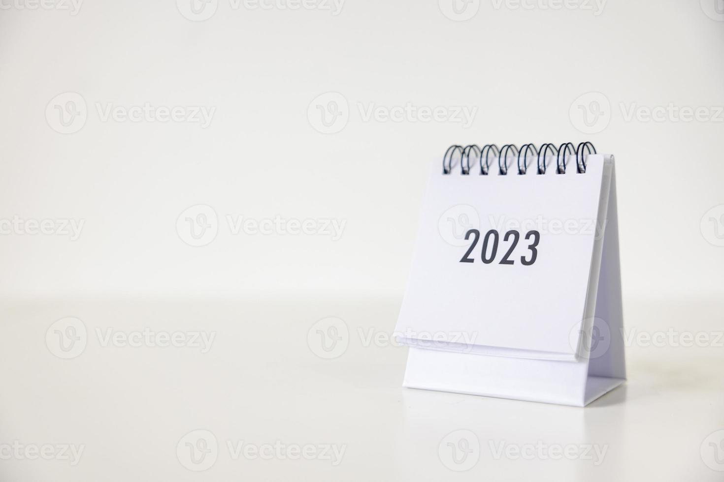 2023 business calendar on office table in new year day. Make a work plan for the start of the year. Concept about Celebration, Business, Christmas, New Year. photo