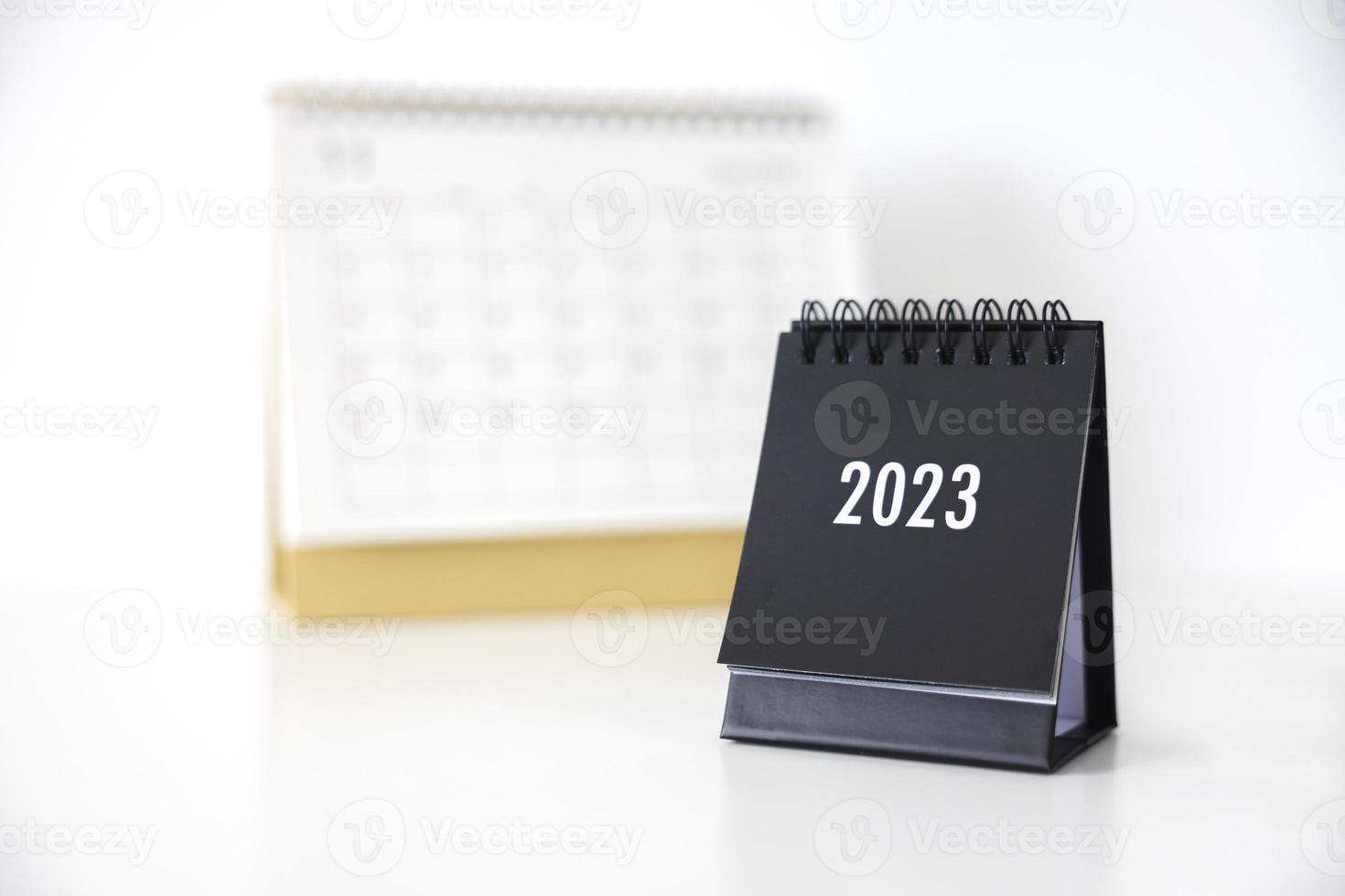 2023 business calendar on office table in new year day. Make a work plan for the start of the year. Concept about Celebration, Business, Christmas, New Year. photo