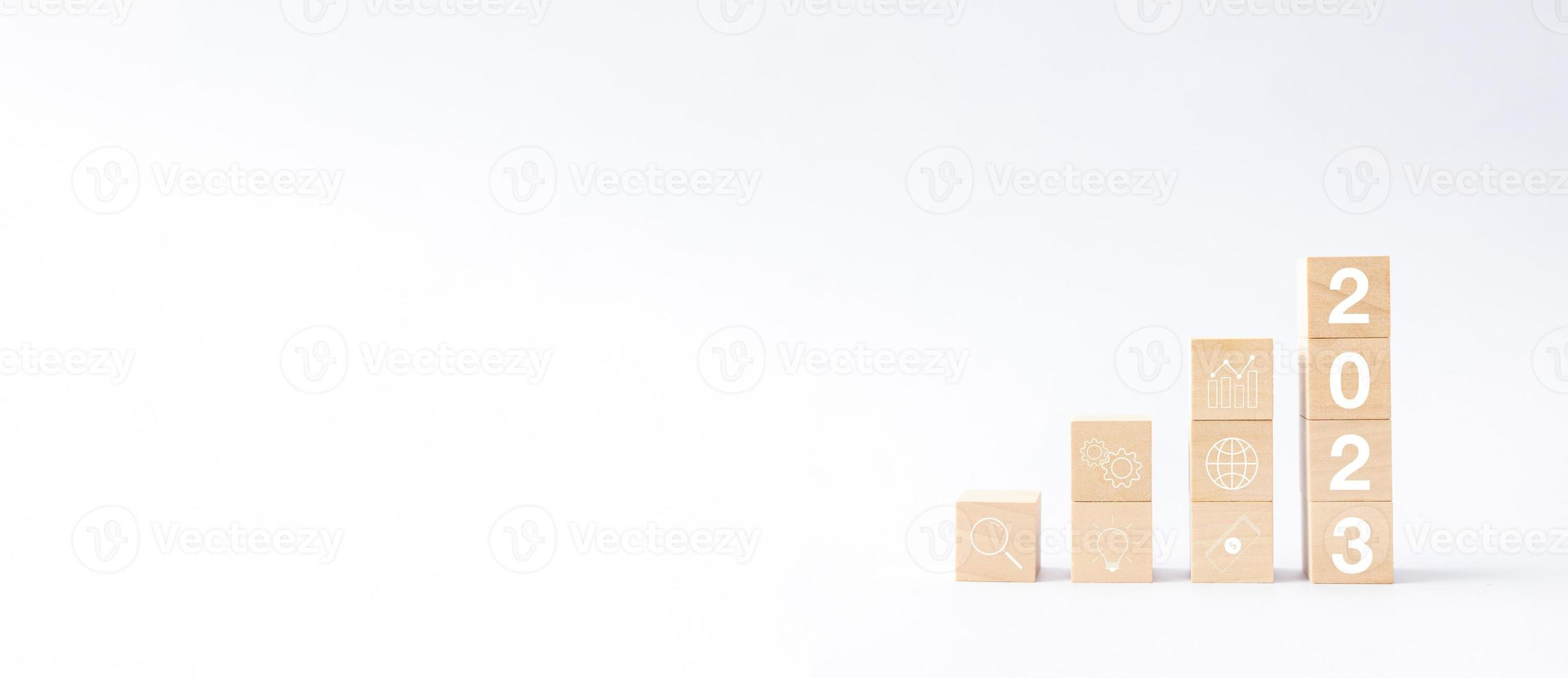 New year 2023 business growing growth concept to success. woods block step with icon concept about business strategy, Action plan, Goal and target, hand stack, project, vision. photo