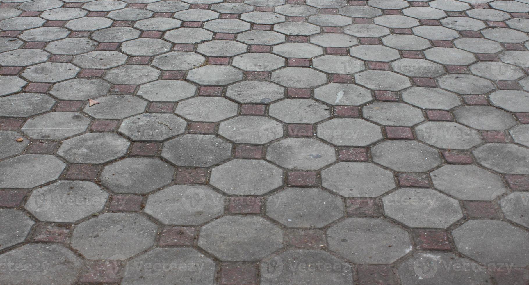 Texture or pattern on the floor with octagon shape bricks in natural sunlight. photo