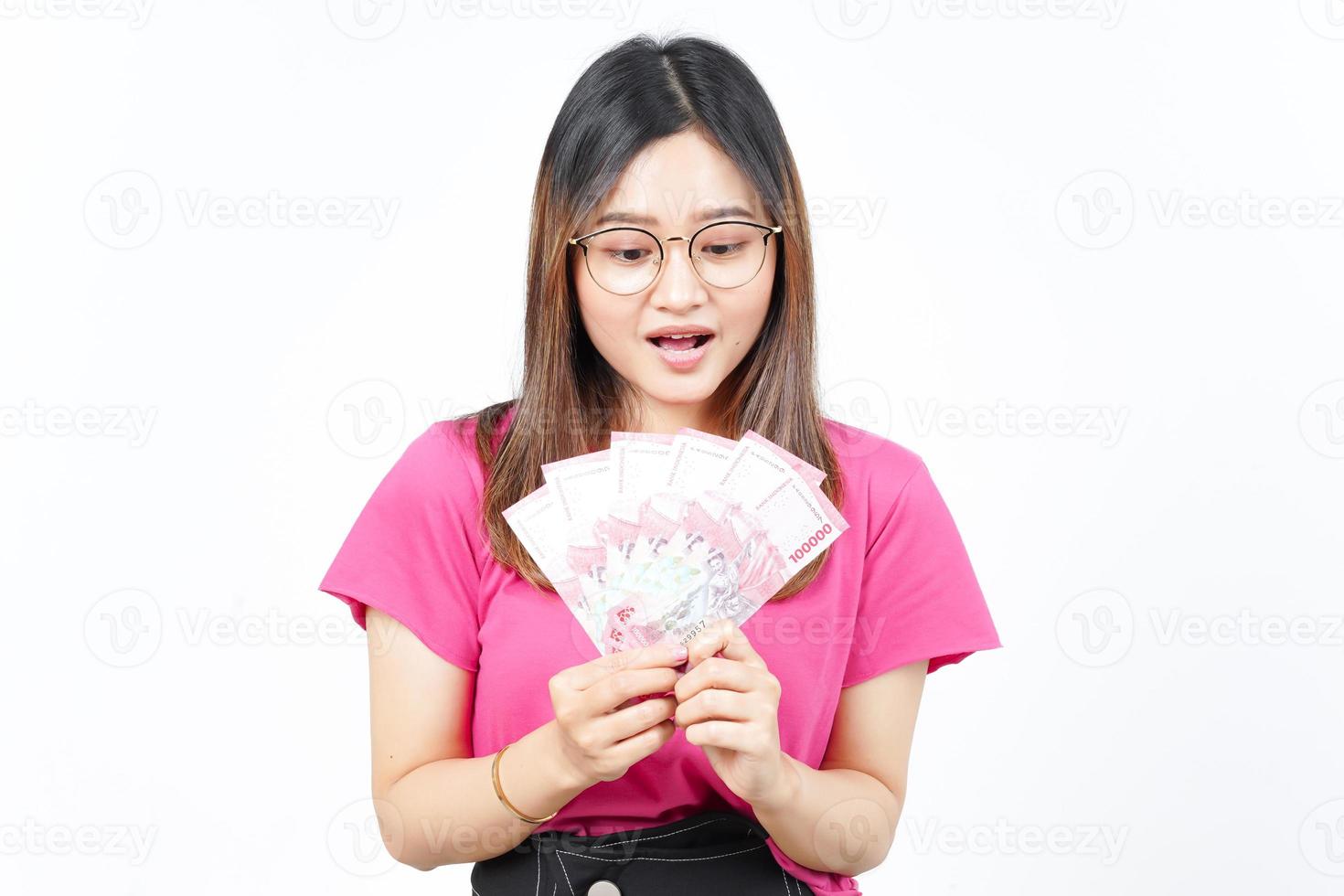 Holding New 100.000 Bank Note Indonesia Rupiah Of Beautiful Asian Woman Isolated On White Background photo