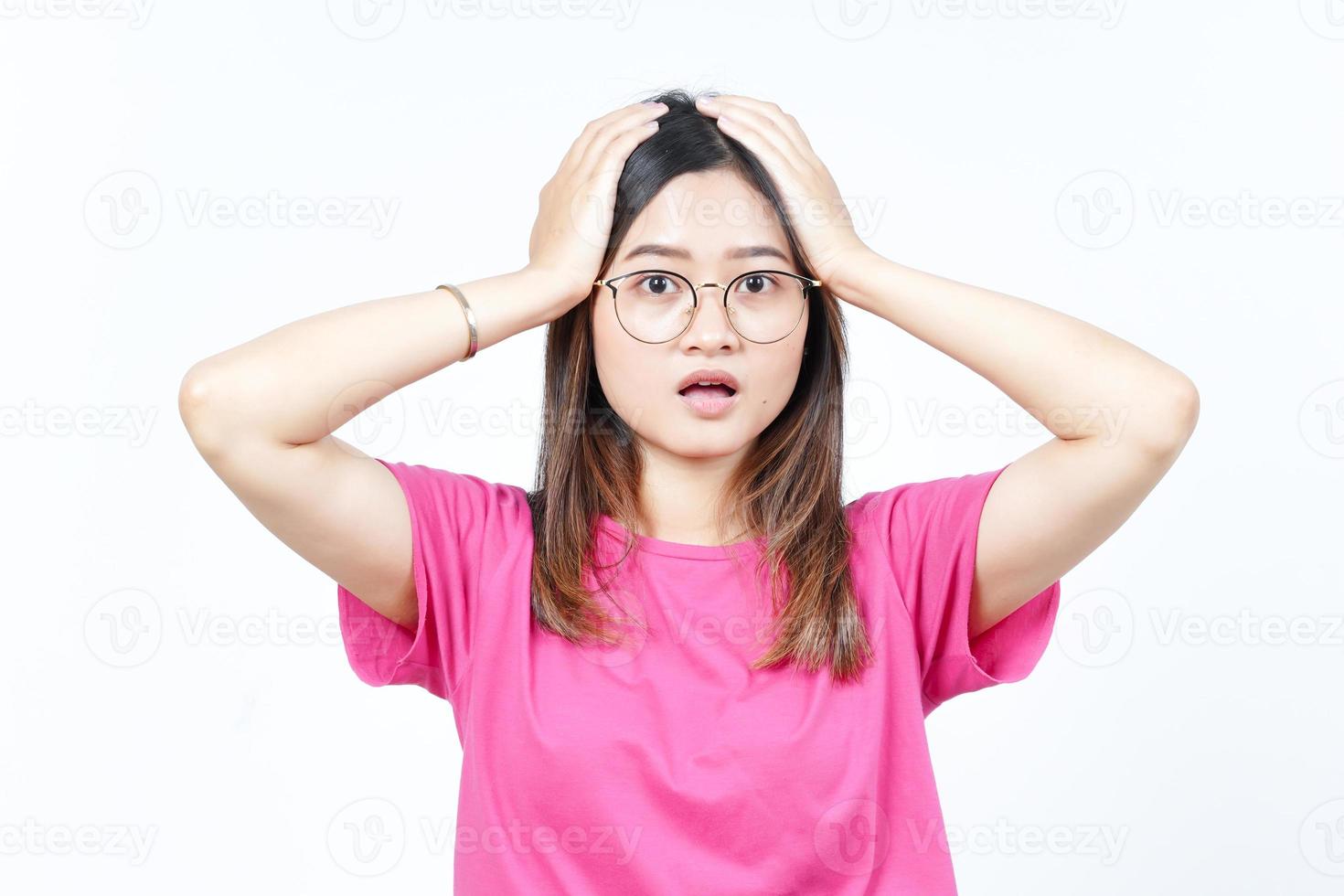 Hands on Head with WOW Face Expression Of Beautiful Asian Woman Isolated On White Background photo