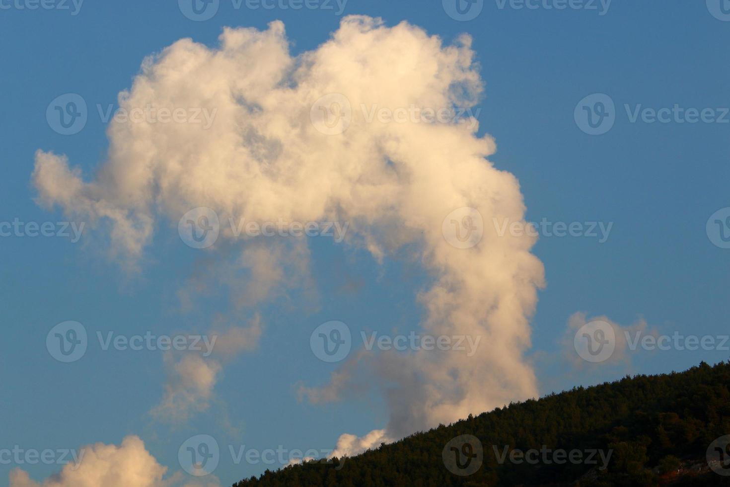 Rain clouds in the sky above the forest. photo