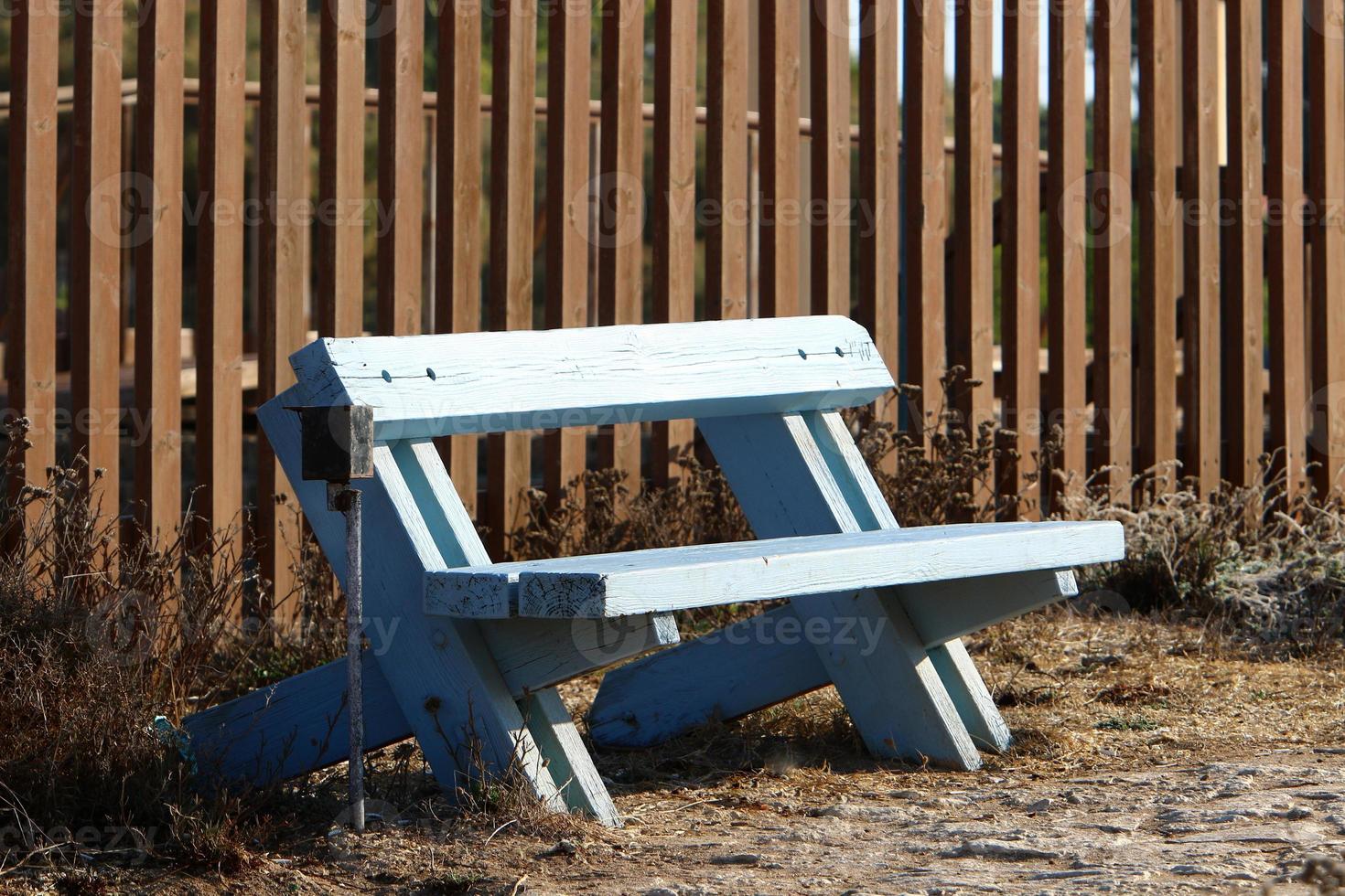 Bench for rest in the city park on the seashore. photo