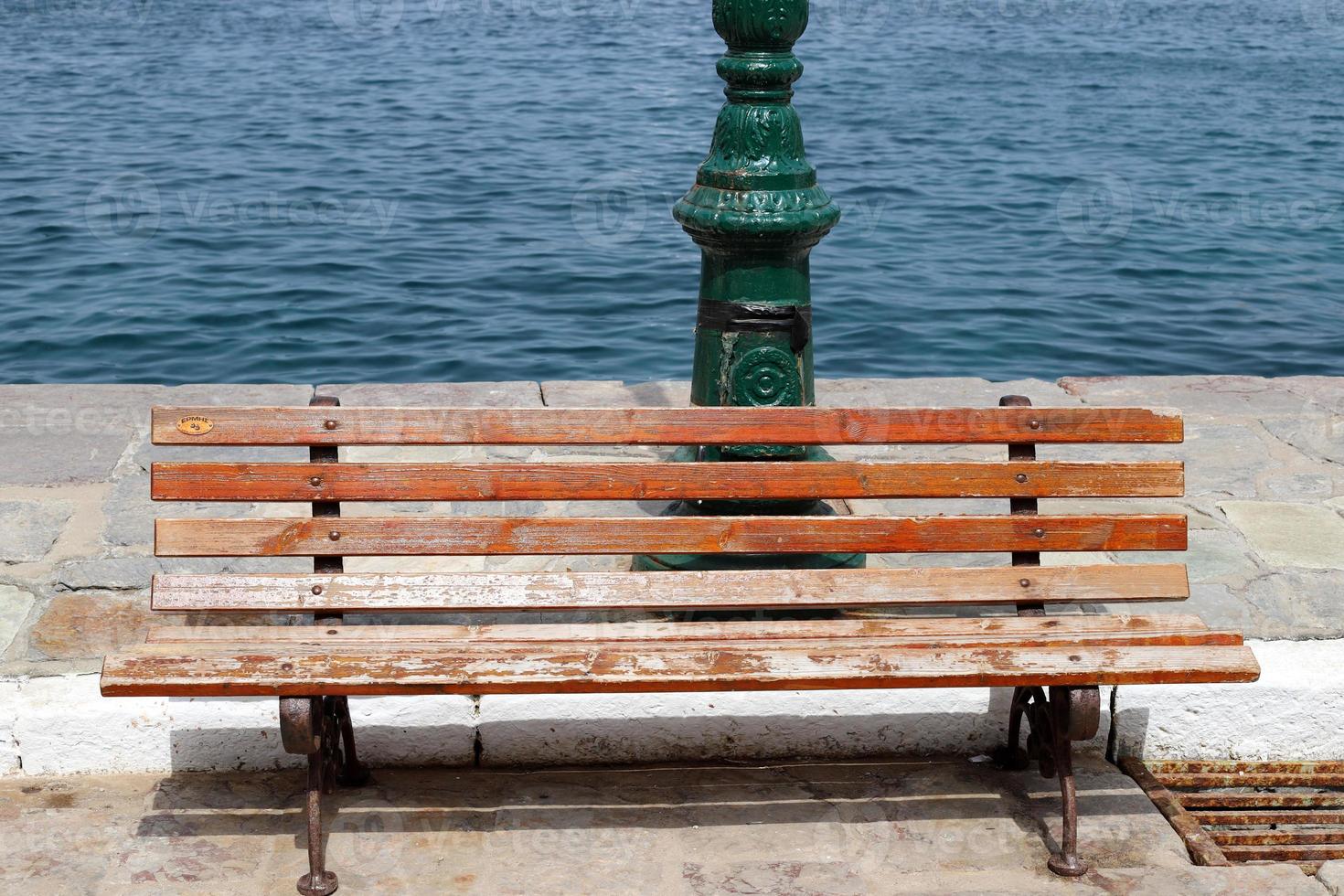 Bench for rest in the city park on the seashore. photo