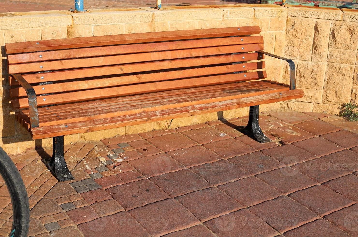 Bench for rest in the city park on the seashore. photo