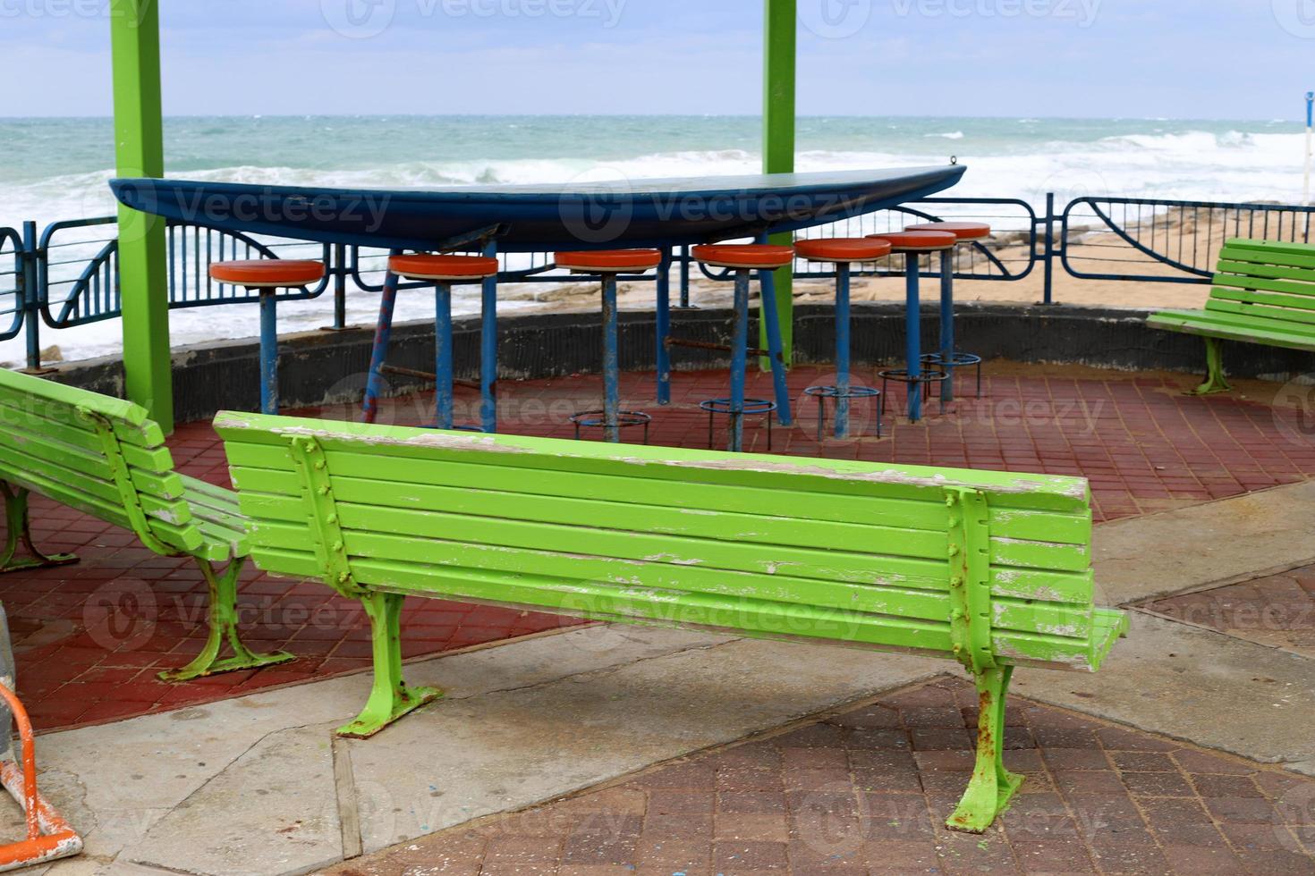 Bench for rest in the city park on the seashore. photo