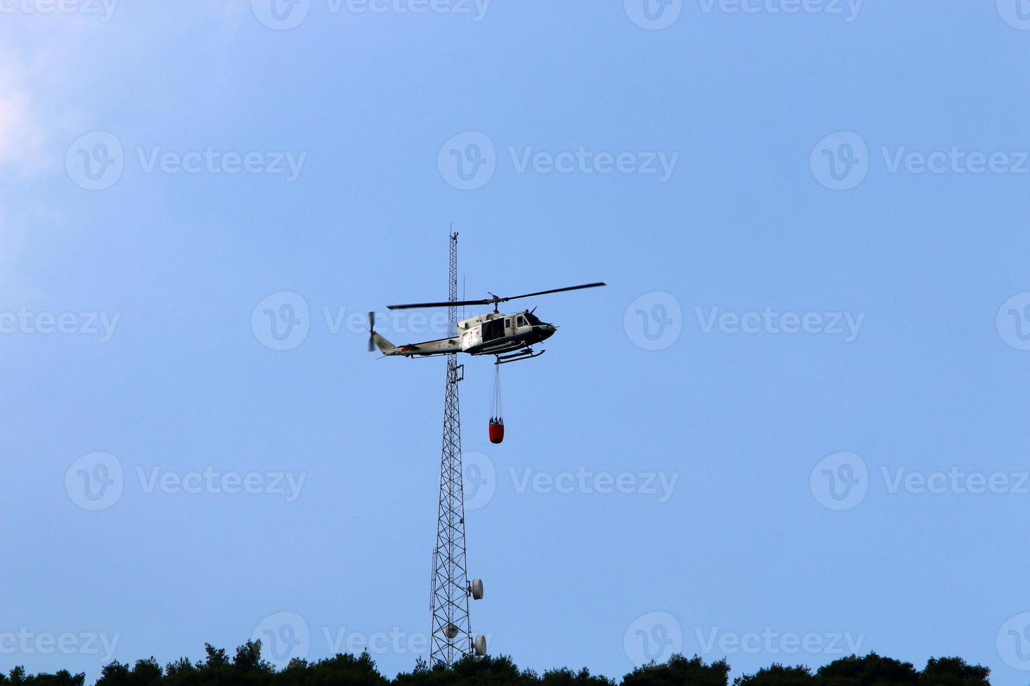 A helicopter puts out a forest fire in the mountains of northern Israel. photo