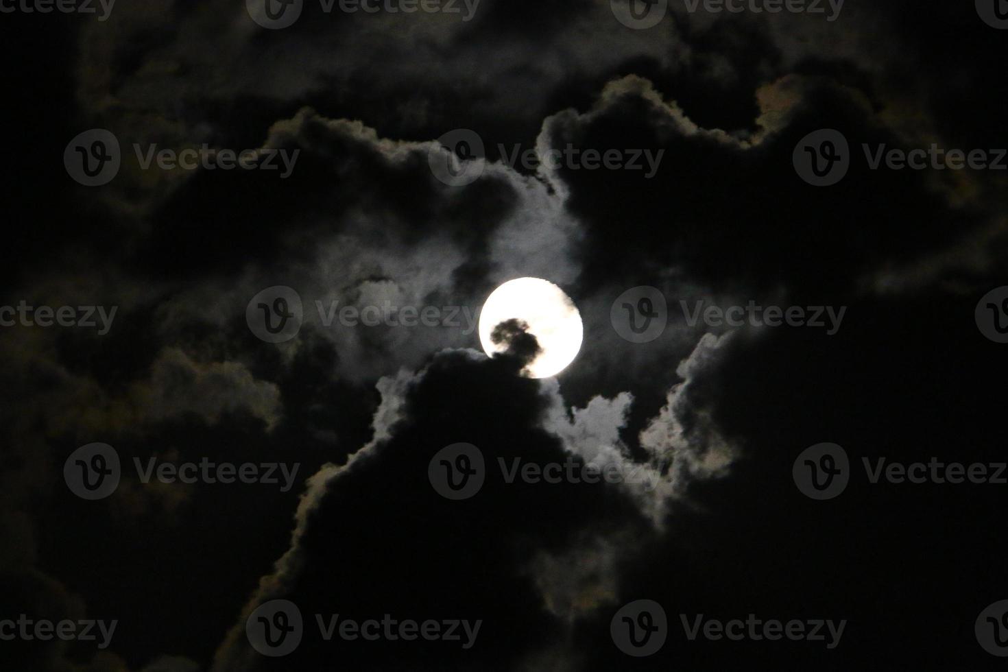 Moon and clouds in the sky over the sea photo