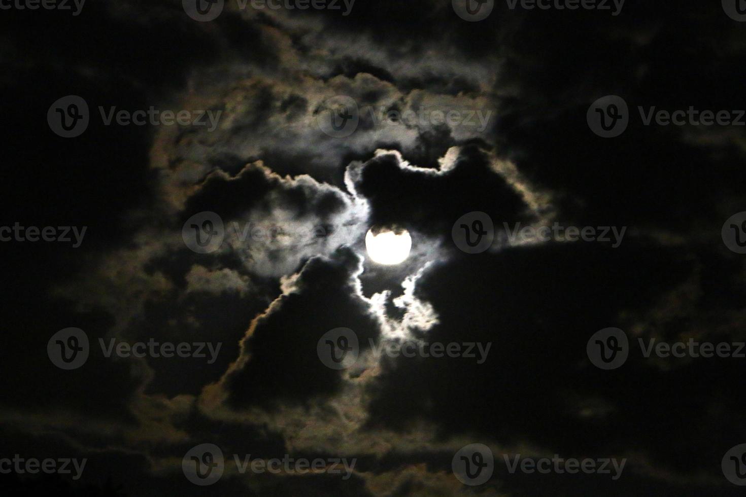 Moon and clouds in the sky over the sea photo