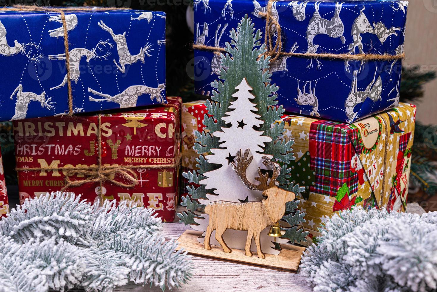 Christmas composition with beautiful decoration, christmas tree and wreath, deer, gifts and accessories in modern home decor. photo
