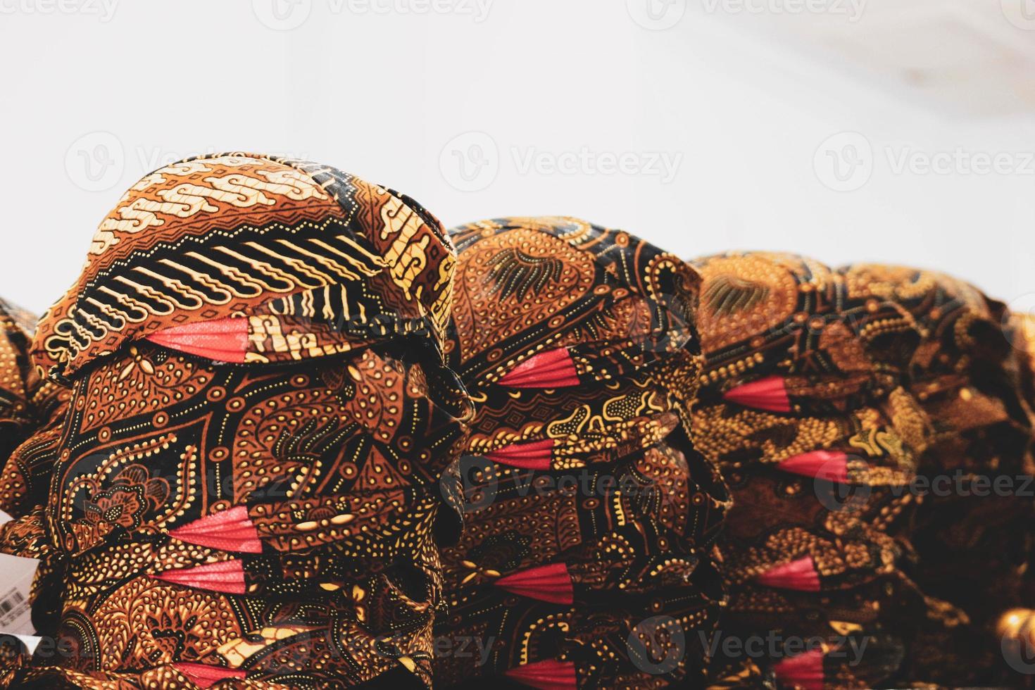 Piles of blangkon sold at a souvenir shop in Jogjakarta. The blangkon is a men's cover or headband in the Javanese traditional dress tradition. photo