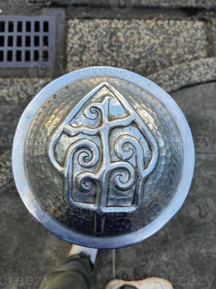 Pedestrian facilities on the Malioboro sidewalks include steel pipe bollards with traditional ornaments or motifs photo