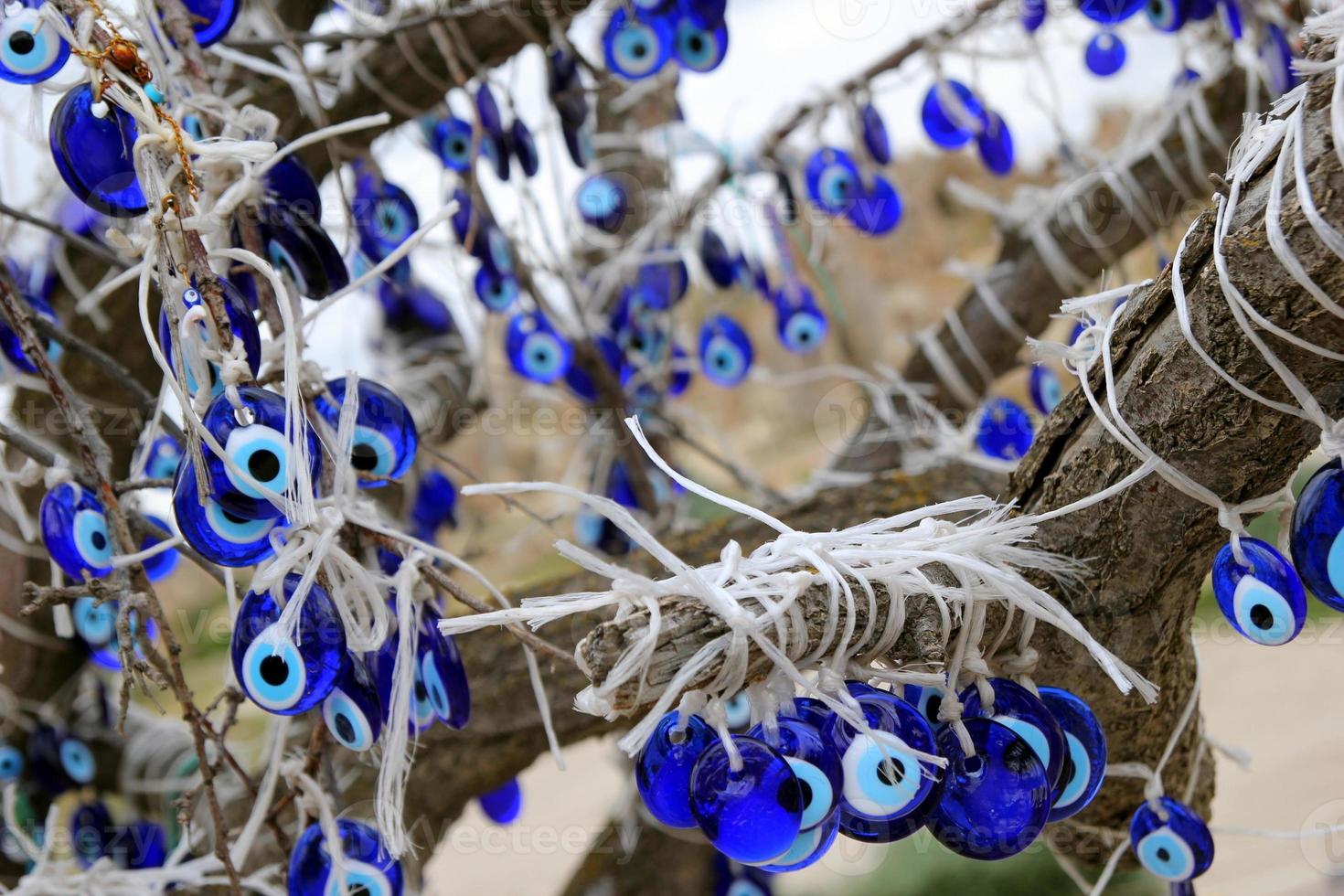 Travel to Goreme, Turkey. The turkish traditional souvenirs 'Cat's eyes' on the tree. photo