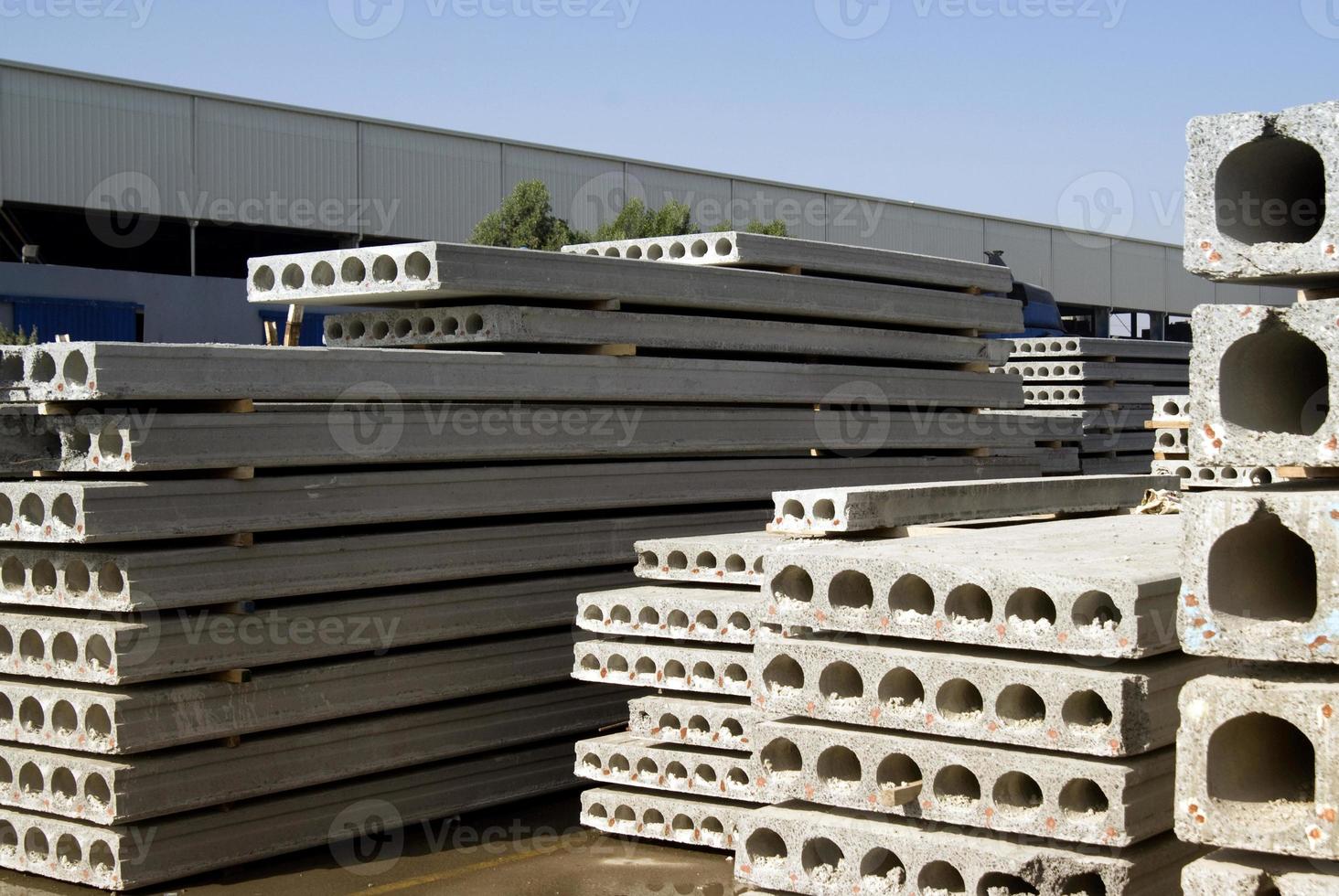 Stack of precast reinforced concrete slabs in a house-building factory workshop photo