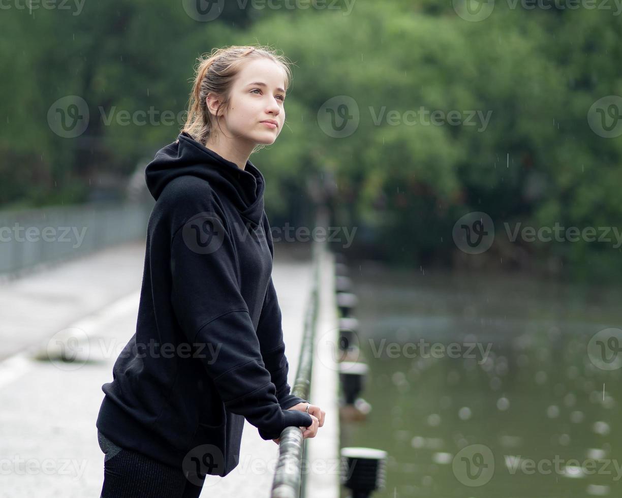 Portrait of young girl smiling. Beautiful woman standing one person outdoor. A cheerful, long brunette haired, brown eyes female has a positive emotion freedom of leisure activity in a natural park. photo