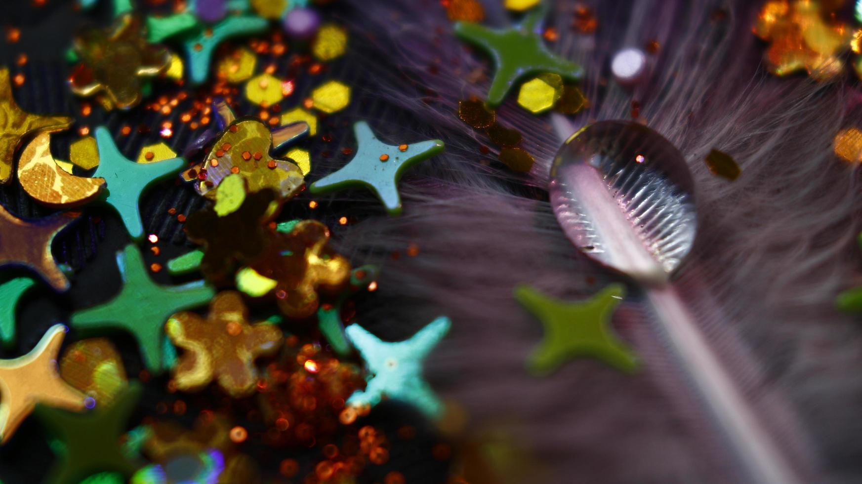 Close-up Of water drop with glitter on it in different colorful loghts in Karachi Pakistan 2022 photo