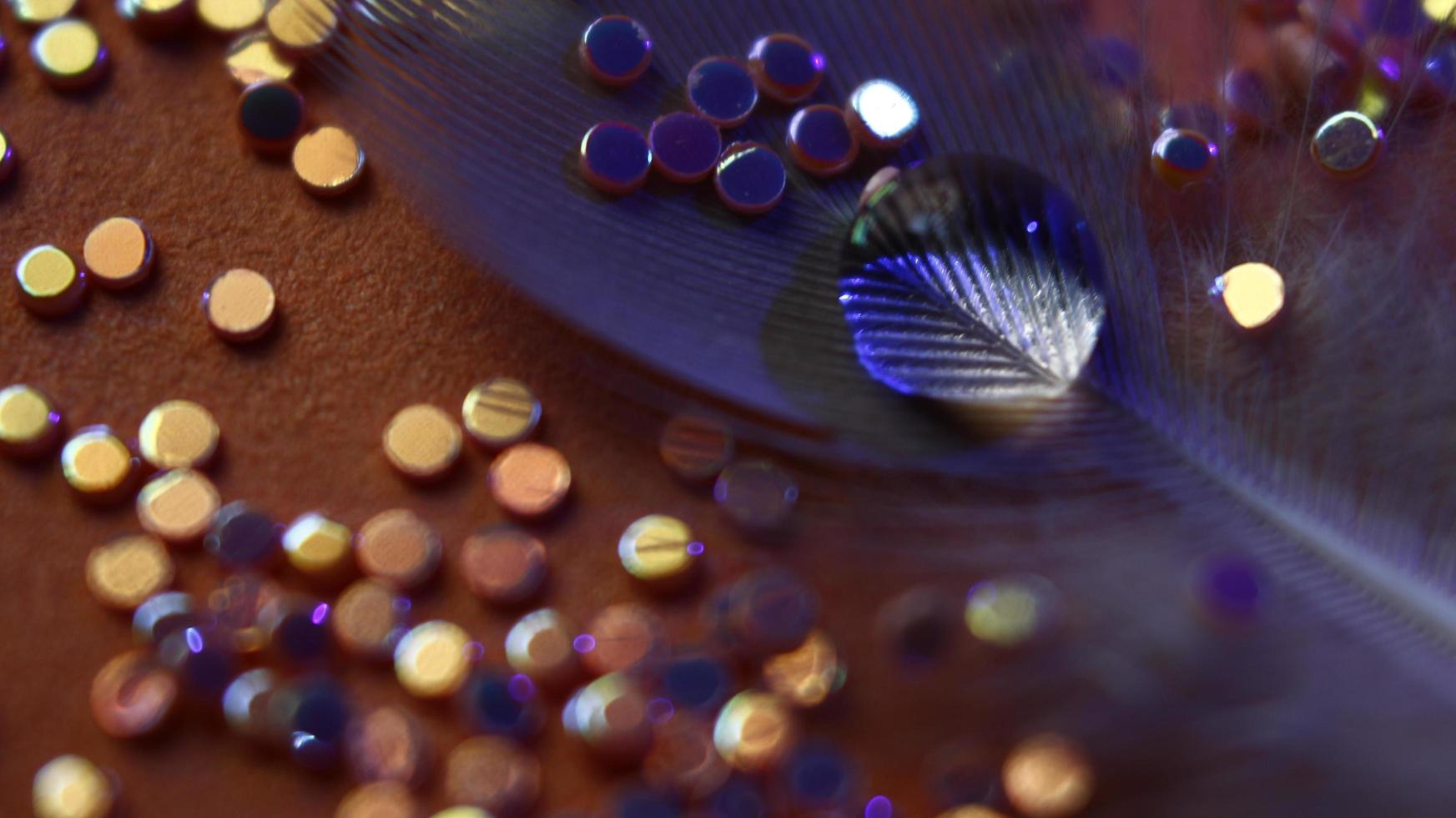Close-up Of water drop with glitter on it in different colorful loghts in Karachi Pakistan 2022 photo