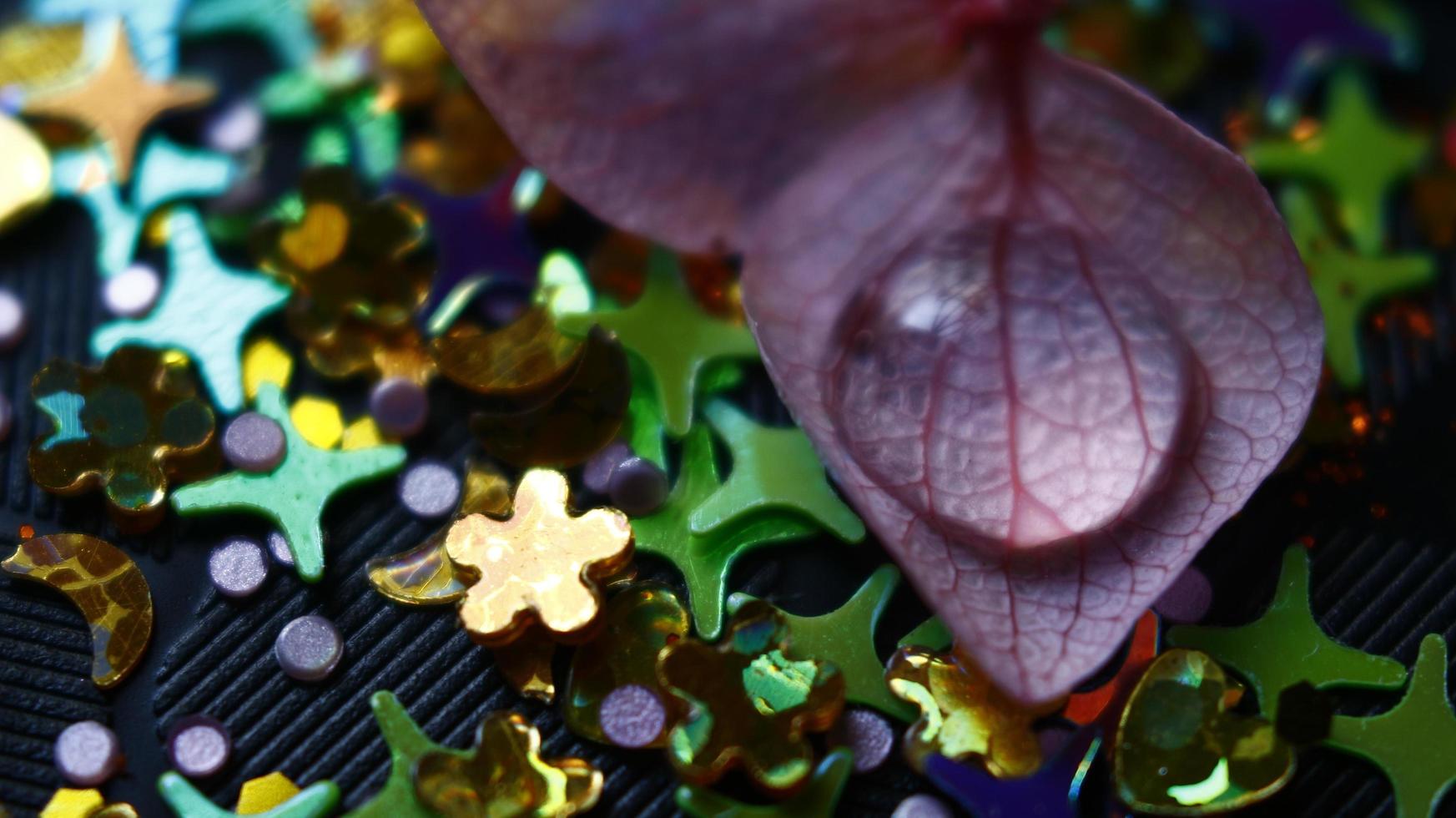 Close-up Of water drop with glitter on it in different colorful loghts in Karachi Pakistan 2022 photo