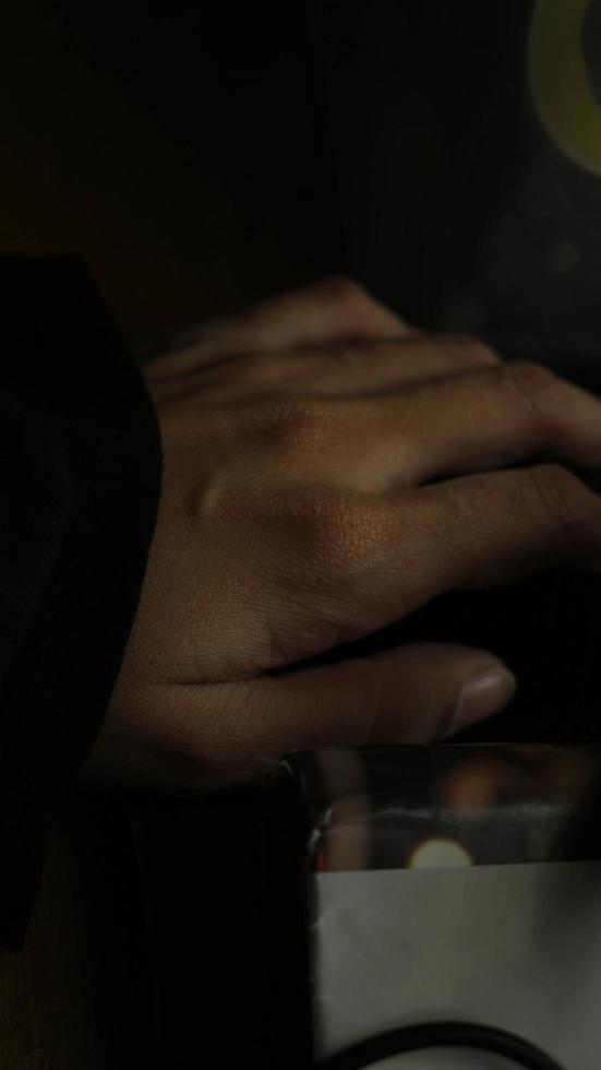 Closeup of a woman's hand on a book in a gloomy setting photo