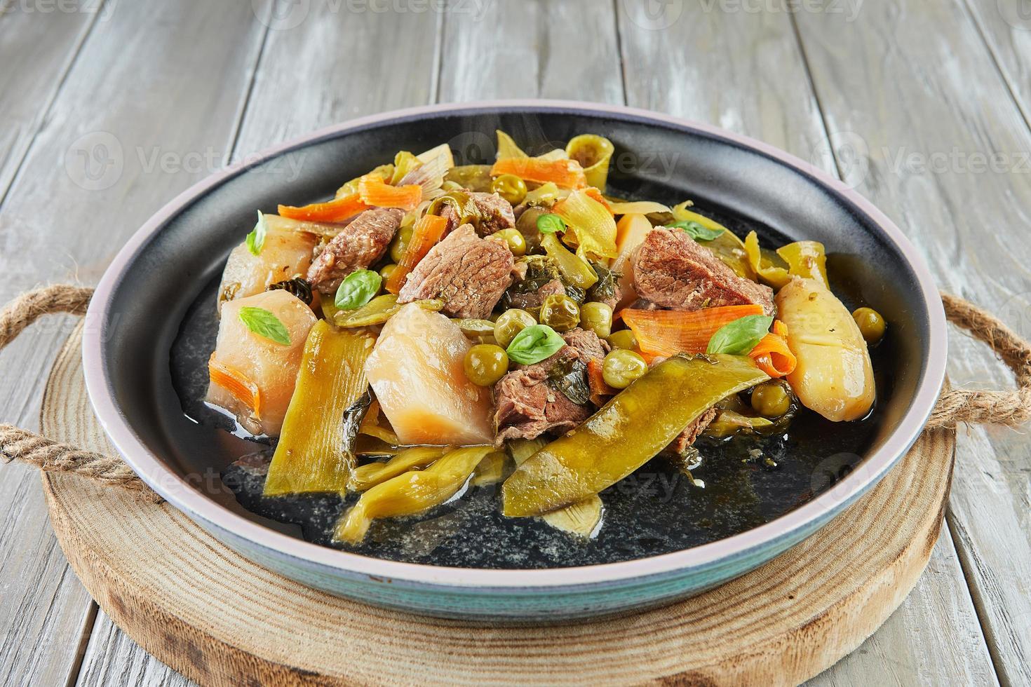 Lamb stew with seasonal vegetables on black plate 16662879 Stock Photo