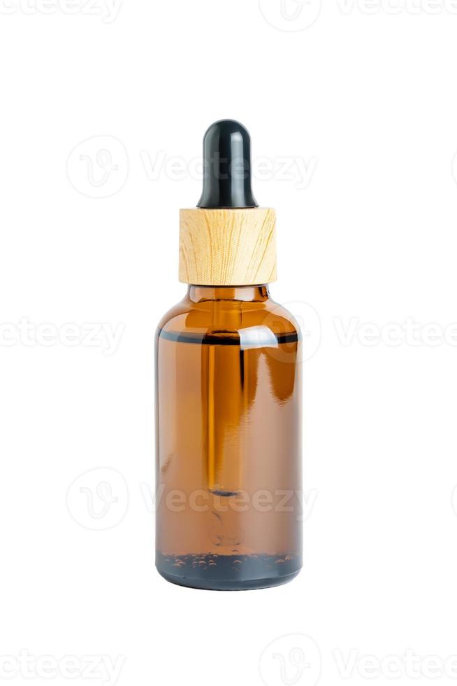 Amber glass bottle dropper with bamboo lid isolated on white background by clipping path. Skin care madicine and cosmetology mockup photo