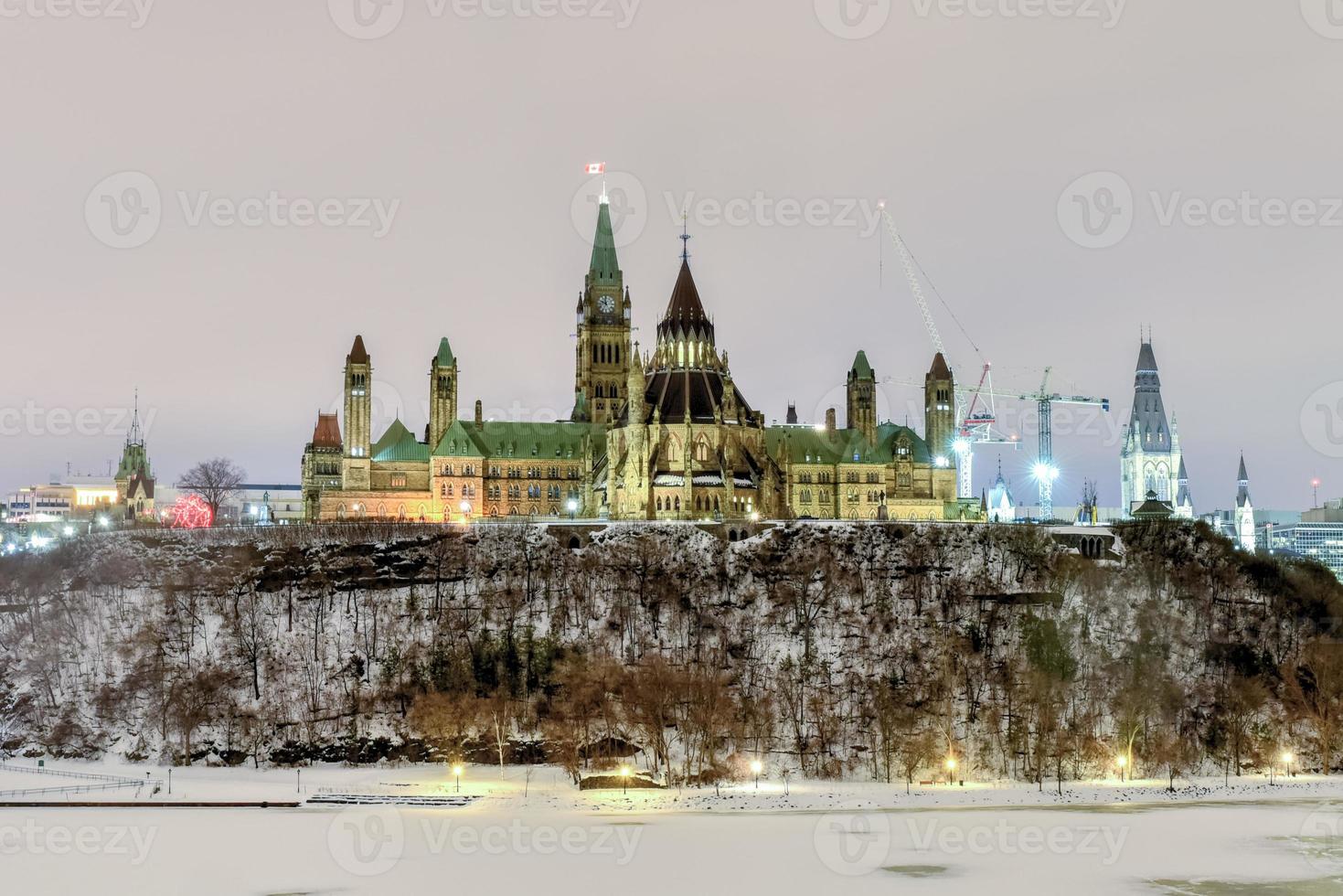 Parliament Hill and the Canadian House of Parliament in Ottawa, Canada during wintertime at night. photo