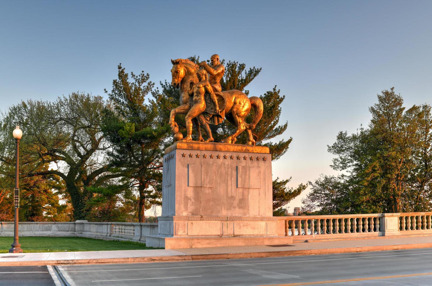 Washington, DC - Apr 4, 2021 -  Arts of War, bronze, fire-gilded statue groups on Lincoln Memorial Circle in West Potomac Park at sunset in Washington, DC photo