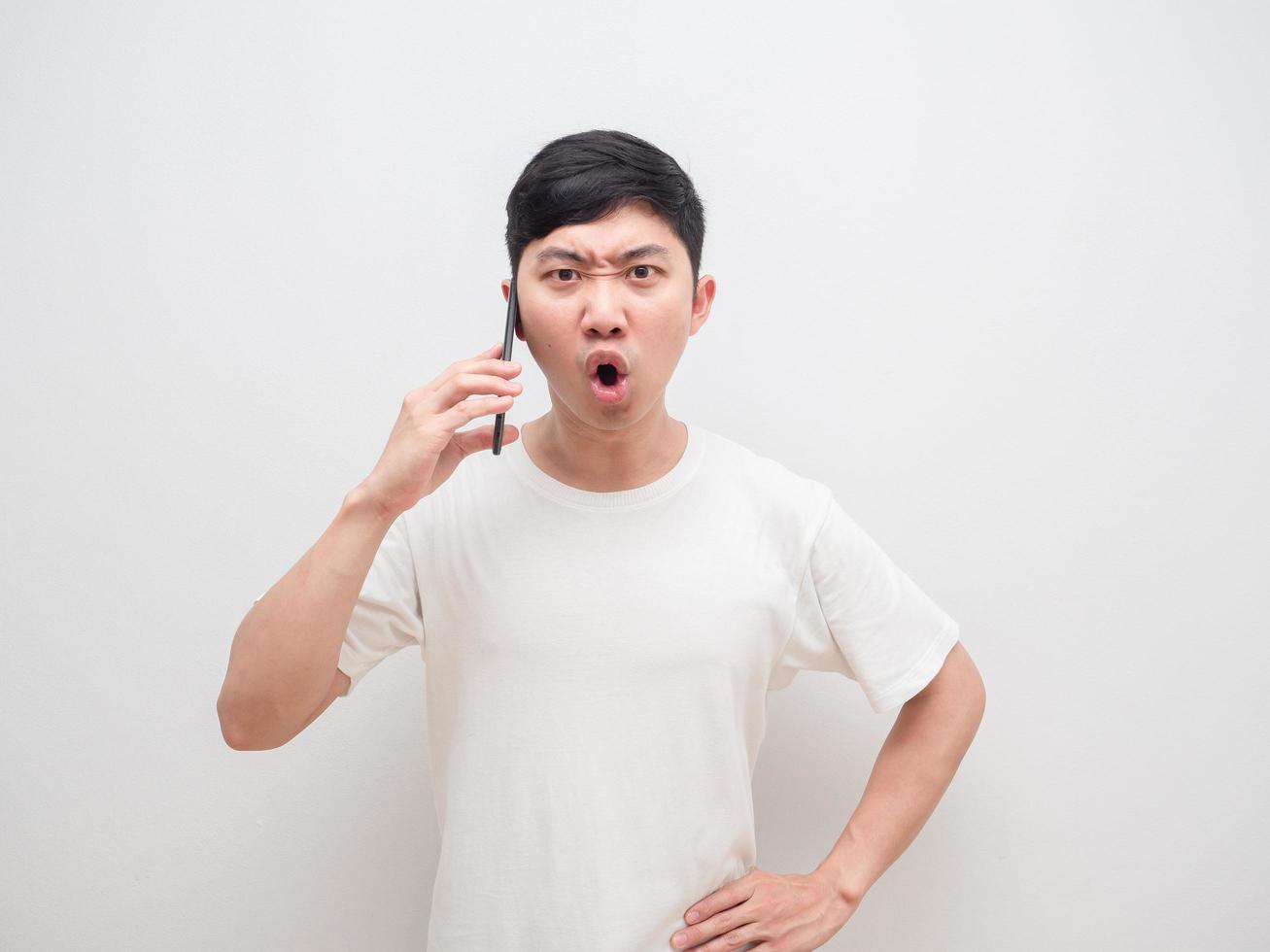Asian man talk with smartphone in hand serious face say no look at camera on white background photo
