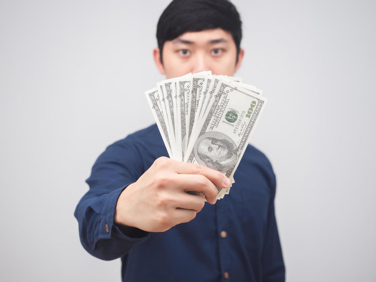 Closeup money in man hand on white background,Businessman show money in hand get salary concept photo