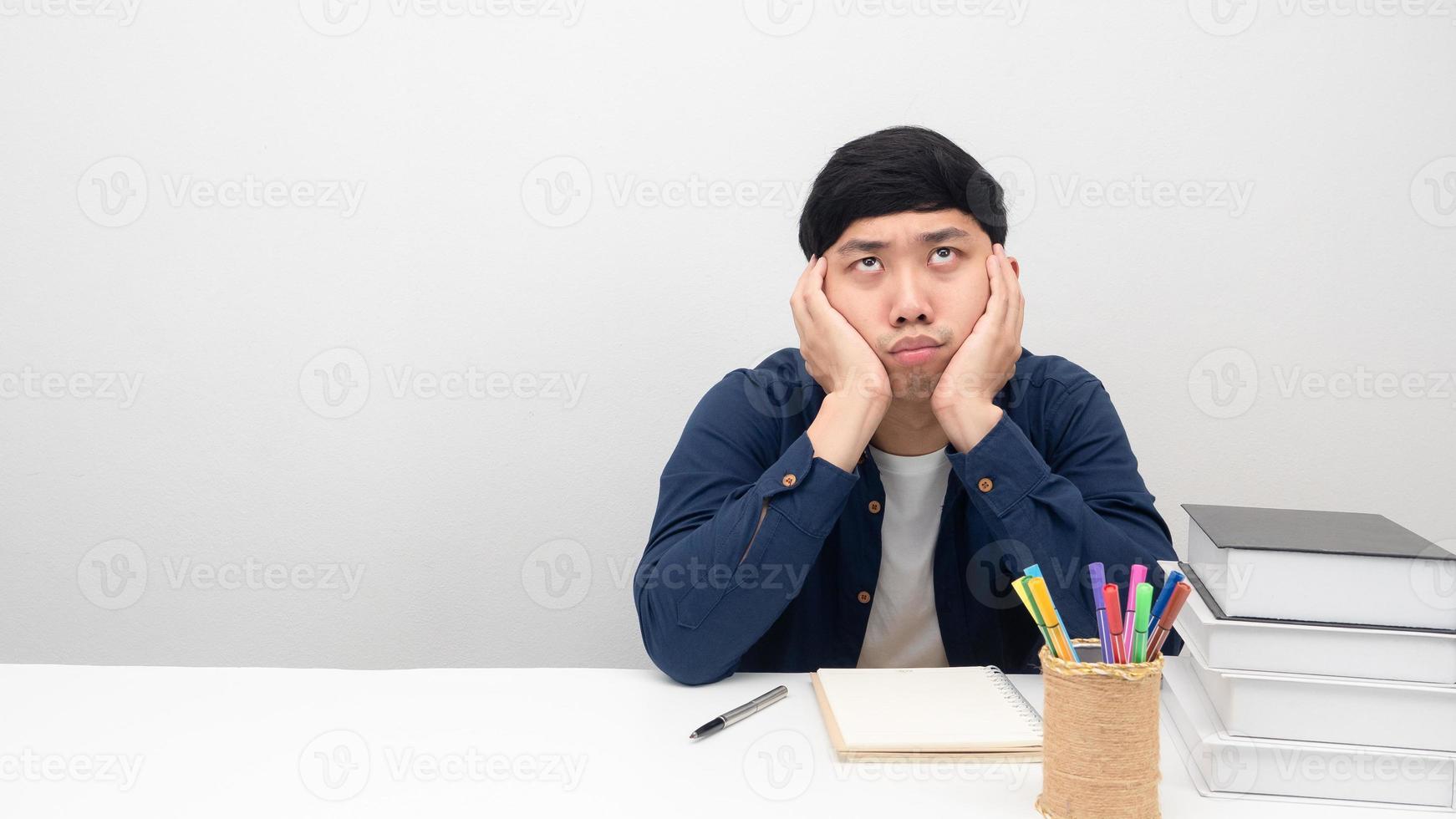 Man sitting at workplace desk gesture bored to working photo