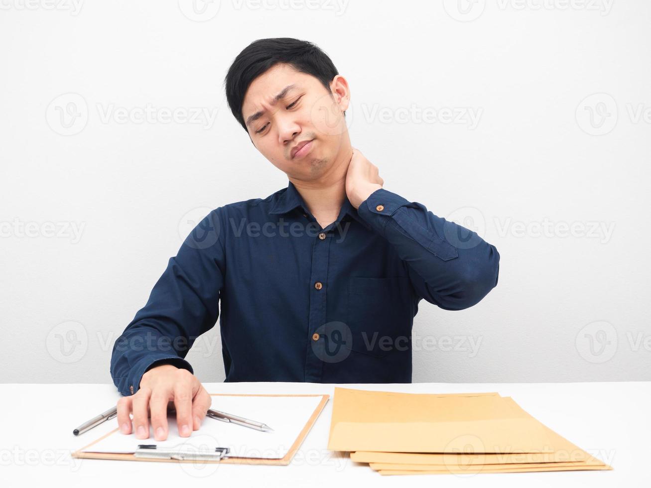 Businessman feeling tried with his work on the table many document to reading photo