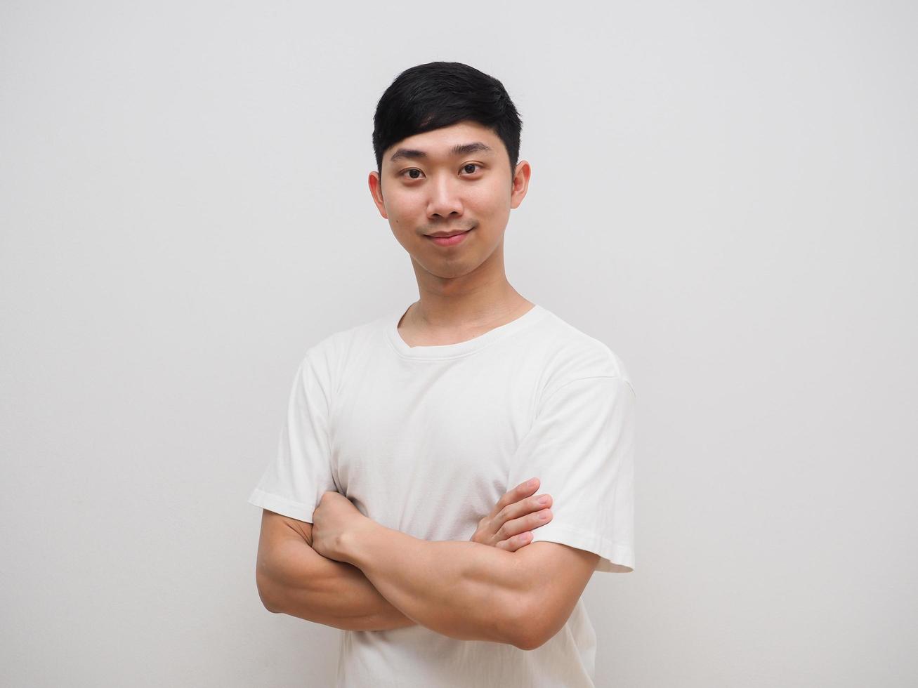 Young asian man cross arm white shirt with happy smile on his face feel confident on white isolate photo