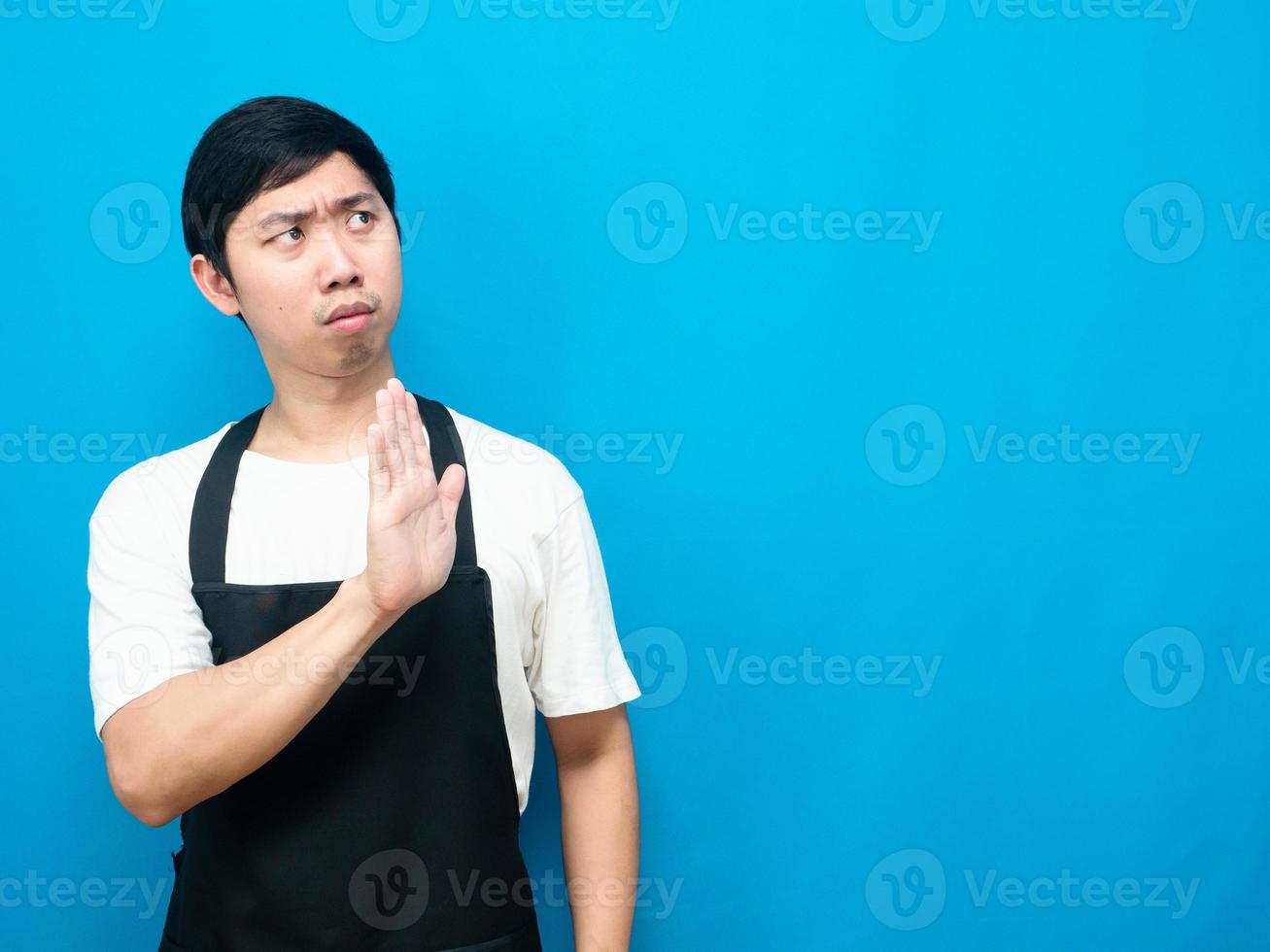 Man wearing apron gesture deny show hand up at copy space photo