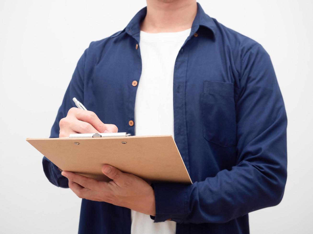 Crop shot of man writing on document board photo