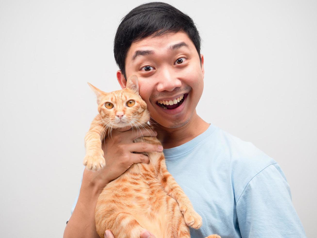 Asian man feeling happy holding lovely cat portrait white background photo