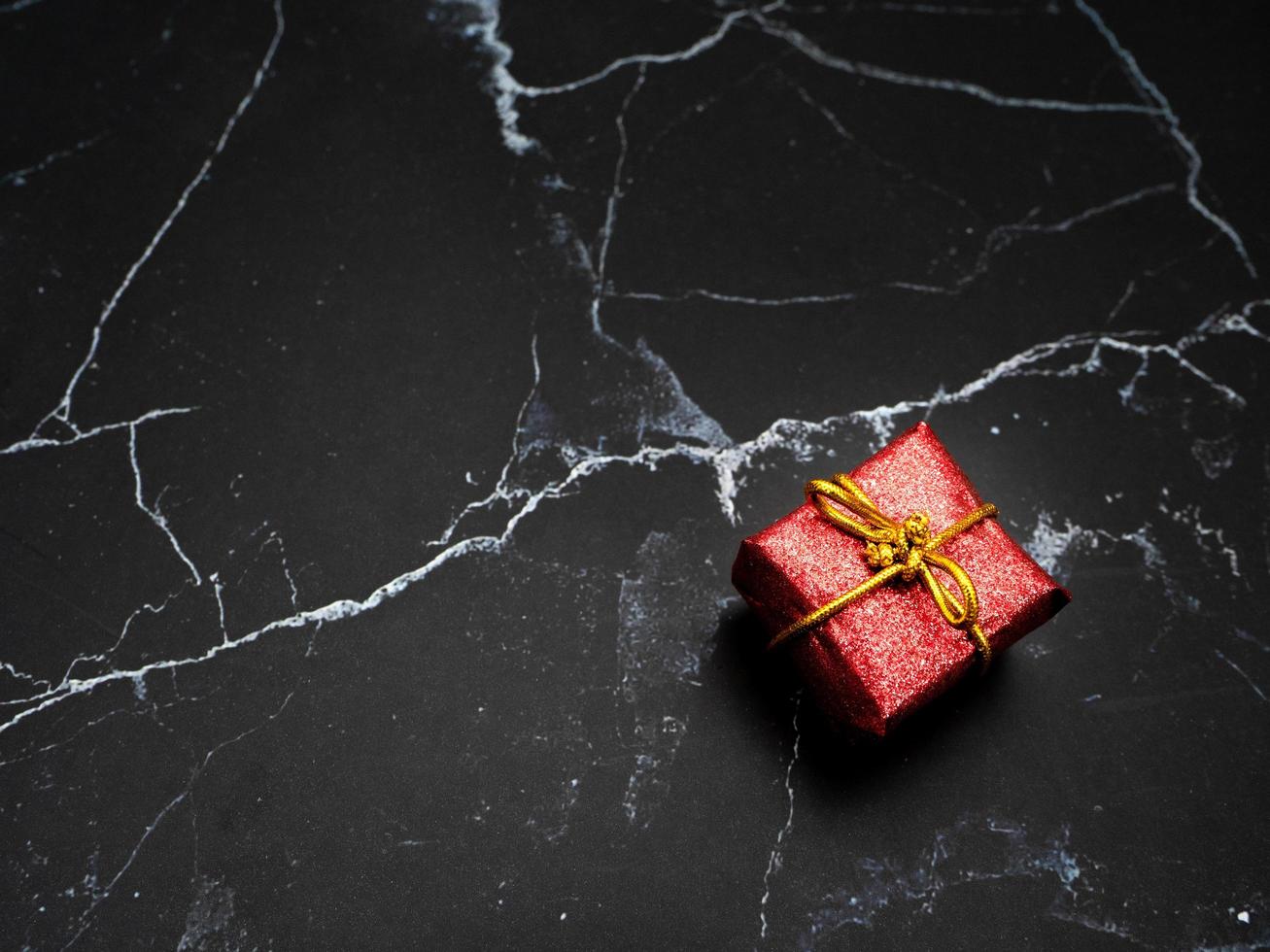 Close up gift box on black marble top view copy space photo