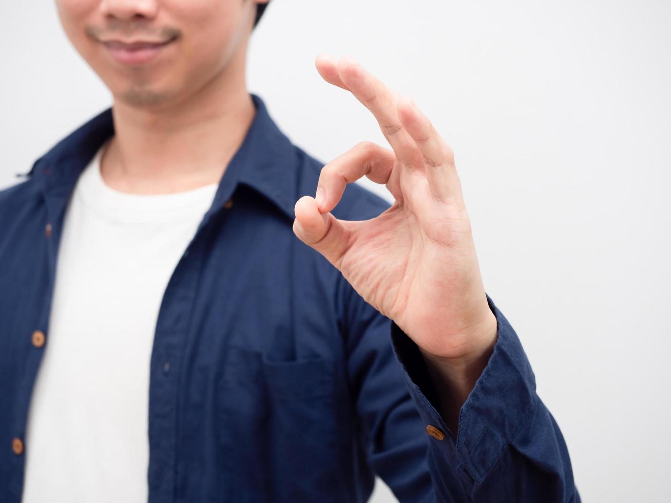 Closeup hand ok of asian man smile face portrait white background photo