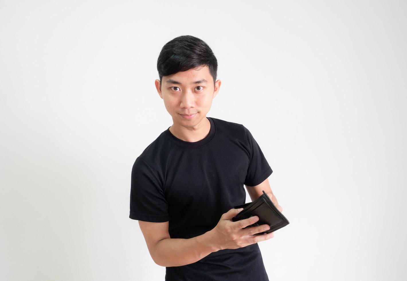 Man black shirt holding wallet in hand and look at camera with confident and smile face on white isolated photo