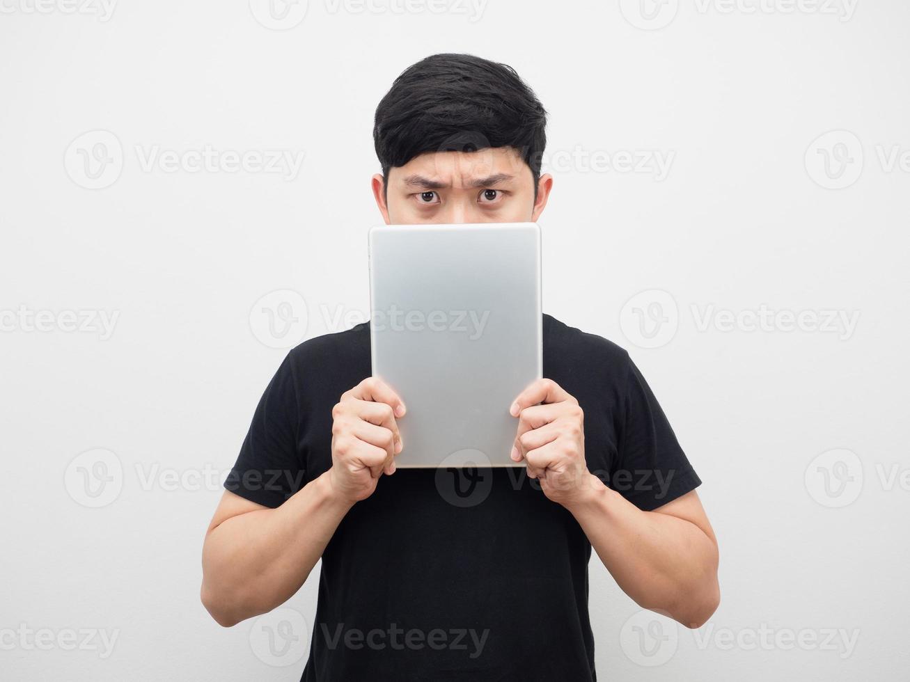 Man holding tablet close his face serious emotion photo