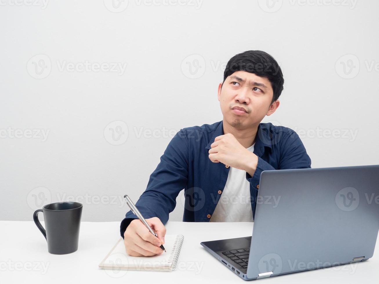 Asian man working at workplace feeling bored and looking at copy space photo